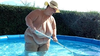 SSBBW with huge natural boobs cleaning the pool in tiny bikini! By Viola Tittenfee